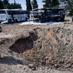 Watch: Bedouins steal fuel from busses damaged by missile