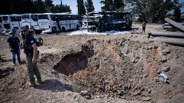 Watch: Bedouins steal fuel from busses damaged by missile