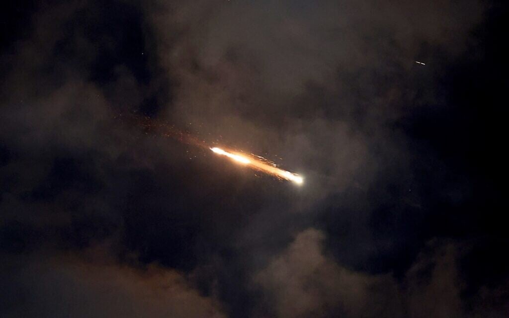 Iran fires missile barrage at central Israel; shrapnel sparks fire on roof of apartment building