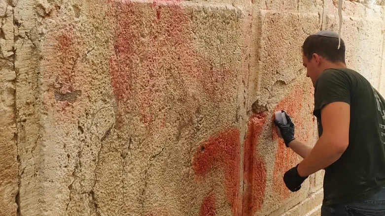 Graffiti removed from Western Wall stones by Antiquities Authority’s preservation team