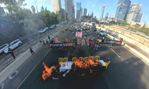 WATCH: Activists block main Tel Aviv highway, set Shabbat table on fire in protest for a Gaza deal