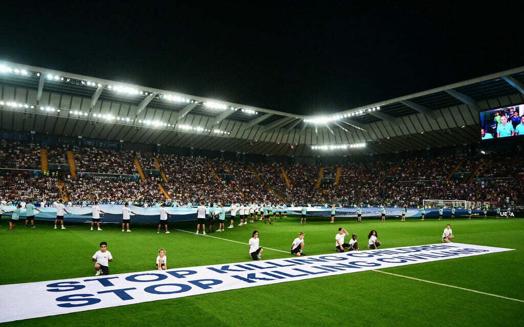 Flouting its own rules, UEFA displays ‘stop killing children’ banner at key match