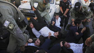 Haredim, police clash during protest on major highway: ‘The state will get prisoners, not soldiers’
