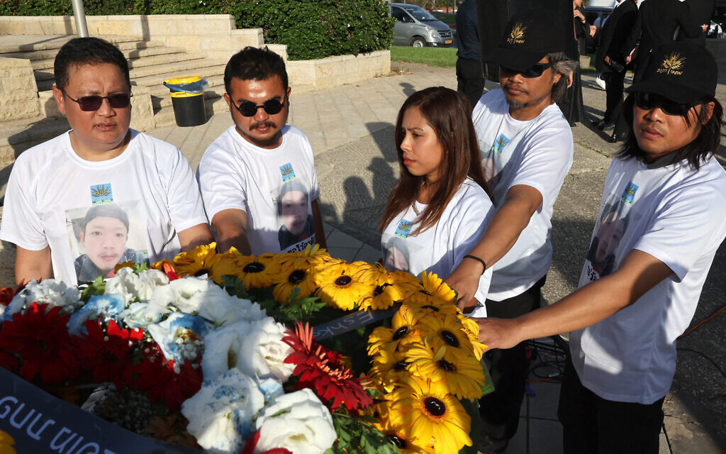 Dozens honor slain Thai hostage at airport as his body is finally flown home