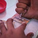 Gazan woman undertakes tiring task of repairing enclave’s tattered banknotes