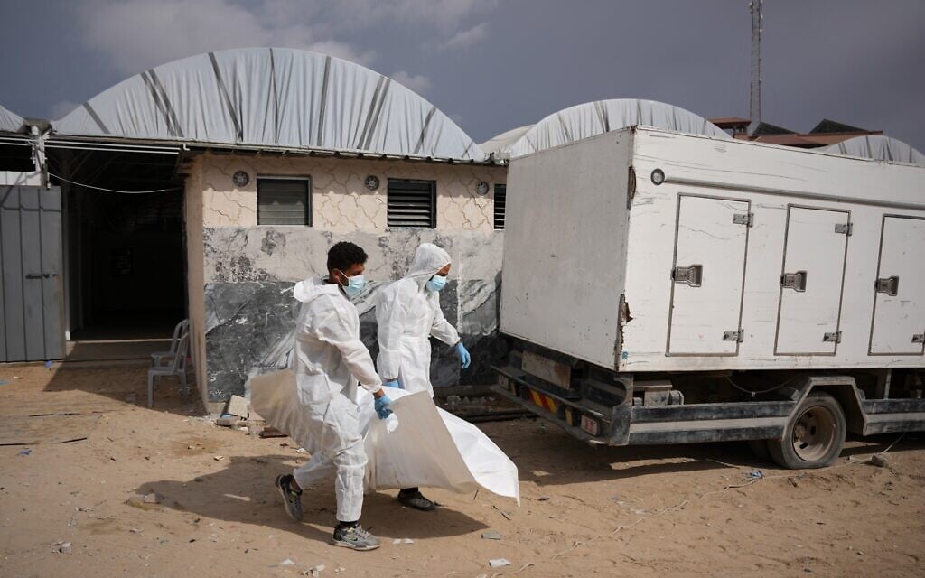 Israel returns 15 Palestinian bodies to Gaza, where displaced families endure winter rains