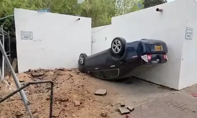 Aftermath: Car flipped and stopped by shelter; no injuries