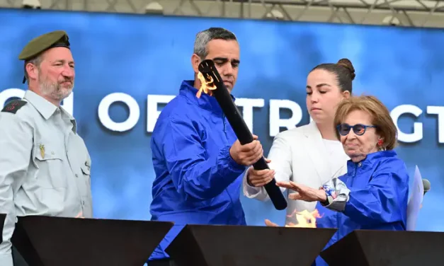 Captivity survivors, bereaved father light memorial torches in Auschwitz