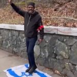 Outrage Erupts After Man Dressed as Hitler, Standing on Israeli Flag, Salutes Boston Marathon Runners