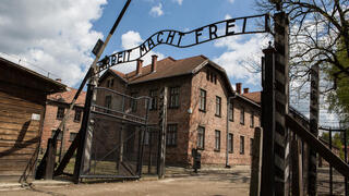 Replica of Auschwitz gate, swastikas placed outside German tax office