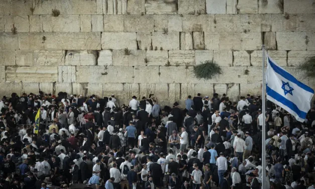 Near the site of destruction: Thousands gather at the Western Wall on Tisha B’Av eve