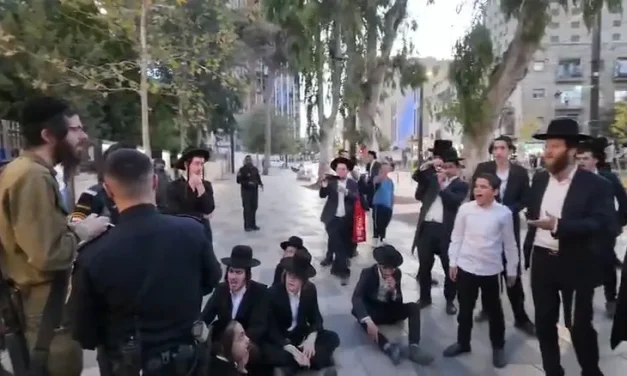 Protesters swarm haredi soldier, shout: “Traitor”