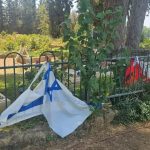 Israeli flags placed beside grave of fallen soldier torn, vandalized