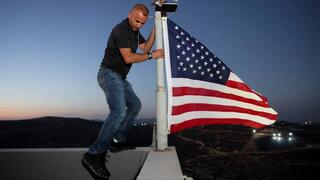 Ohio man arrived at his home in  West Bank village of Qusra and raised an American flag
