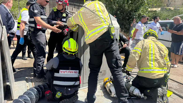 Dramatic rescue: Man pulled alive from underground Jerusalem garbage container