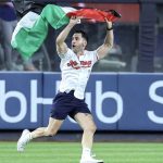Fan carrying a Palestinian flag ran onto the field in Yankee Stadium during 9/11 commemorations