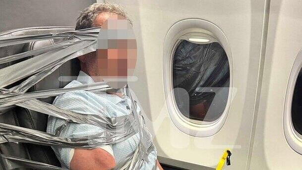 Watch: Drunk American Airlines passenger duct-taped to seat after alleged racist outburst