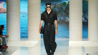 Men’s clutch bags are everywhere, and fashion’s latest status symbol is anything but practical