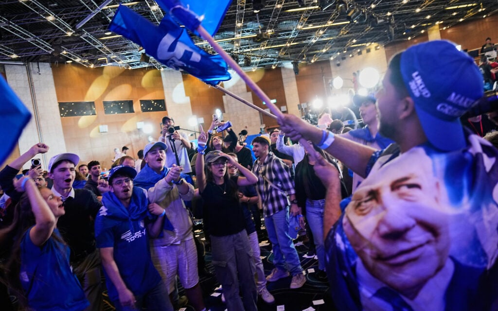 PM celebrates with supporters as exit polls updated in his favor, but refrains from declaring victory