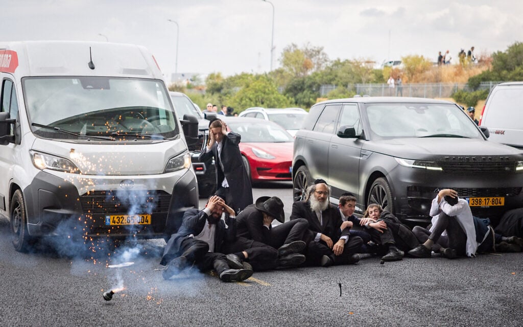 Ultra-Orthodox block main highway in rush hour protest over draft dodgers’ arrest