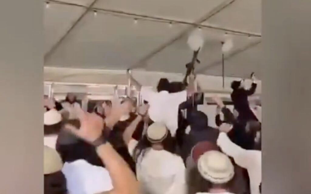 Rifle-wielding settler extremists filmed dancing at wedding to anti-Zionist anthem