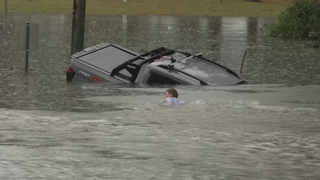 Australian reporter dives into floodwaters to save driver before car disappears